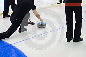 Team members play in curling