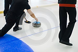 Team members play in curling