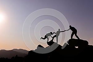 Team of mountaineers climbing rocks