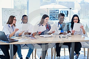 Team of multiethnic doctors having a meeting in conference room in the modern hospital. Group of multiethnic doctors are