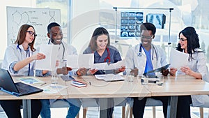 Team of multiethnic doctors having a meeting in conference room in the modern hospital. Group of multiethnic doctors are