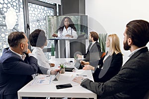 Team of multiracial five business people, healthcare experts, having video conference meeting with young, pretty African
