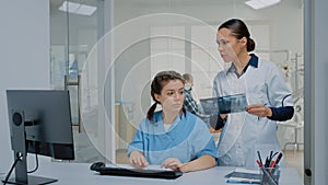 Team of nurse and stomatologist examining x ray and computer