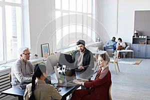 Team of Office Workers Using Computers