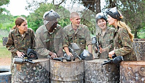 Team of paintball players discussing past game