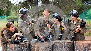 Team of paintball players discussing past game