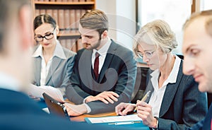 Team of partners in a law firm working diligently on a case