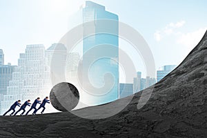 Team of people pushing stone uphill