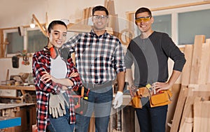 Team of professional carpenters in workshop photo