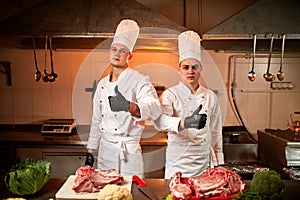 Ð team of professional chefs cook meals in the kitchen of restaurant.  Chief chef preparing dish using different food ingredients