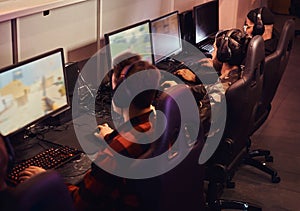 A team of professional cyber sportmans, trains for the championship, plays in a multiplayer video game on pc in a gaming