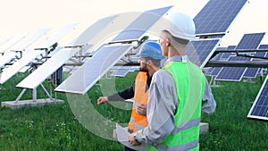 A team of professional engineers learning the design of the solar plant paper plan.