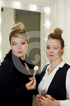 A team of professional stylists, makeup artists.In the hands of brush. Selection of image. Creative work in the beauty