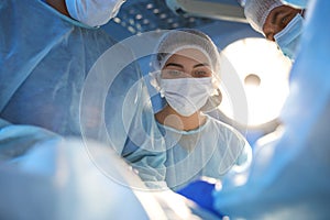 Team of professional surgeons performing operation