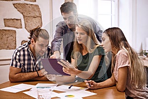 Team of professionals interacting with tablet pc