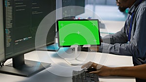 Team of programmer using green screen tablet, working in server farm