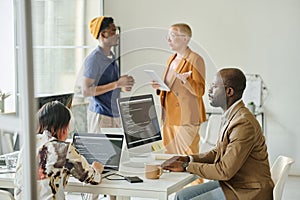 Team of programmers cooperating at meeting