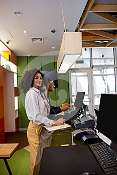 Team of receptionists working at the hotel reception desk