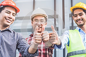 Team of renovation contractor showing thumbs up to guaranteed quality work