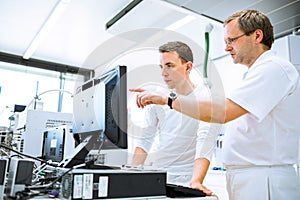 Team of researchers carrying out experiments in a lab