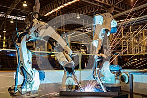 Team robots are welding part in automotive industrial factory