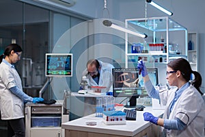 Team of scientific researchers working with professional modern equipment in laboratory