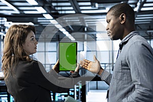 Team of server hub engineers using green screen laptop