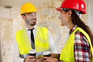 Team of smiling architects at coffee break