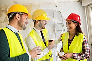 Team of smiling architects at coffee break
