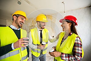 Team of smiling architects at coffee break