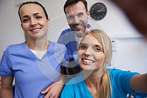 Team of smiling dentists in dentist`s office