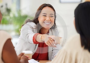 Team of smiling diverse business women shaking hands in office after meeting in boardroom. Group of happy professionals