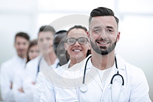 Team of smiling professional doctors standing together