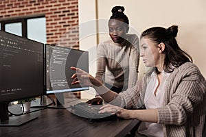 Team of software developers talking about programming