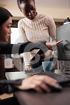 Team of software developers talking about source code