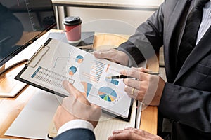 Team of stockbrokers Discussing with display screens Analyzing data, graphs and reports of stock market trading for investment