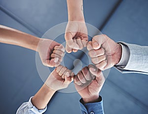 Team success and motivation fist bump of business people with teamwork, work support hand sign. Office group hands