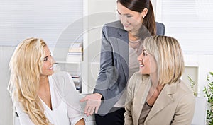 Team: Successful business team of woman in the office talking to