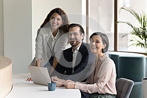 Team of successful different aged businesspeople meeting at workplace table