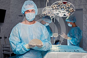 Team surgeon at work in operating room. breast