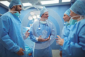 Team of surgeons having discussion in operation theater