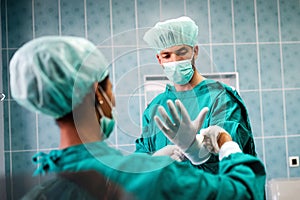 Team of surgeons in the operating room preparing for surgery