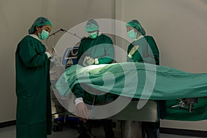 A team of surgeons in the operating room . A team of doctors standing in a hospital. Group of doctors wearing masks in the operati