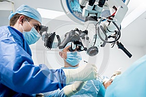 A team of surgeons performing brain surgery to remove a tumor.