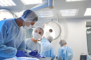 Team of surgeons performing operation in clinic