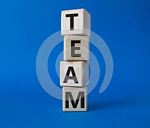 Team symbol. Concept word Team on wooden cubes. Beautiful blue background. Business and Team concept. Copy space