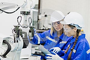 Team technician engineer using remote control automation robotics at industrial modern factory. woman working at factory