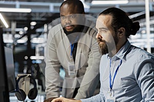 Team of technicians in data center using PC to update storage arrays software