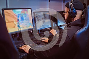 Team of teenage gamers plays in a multiplayer video game on pc in a gaming club. photo