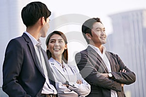 Asian business people talking outdoors